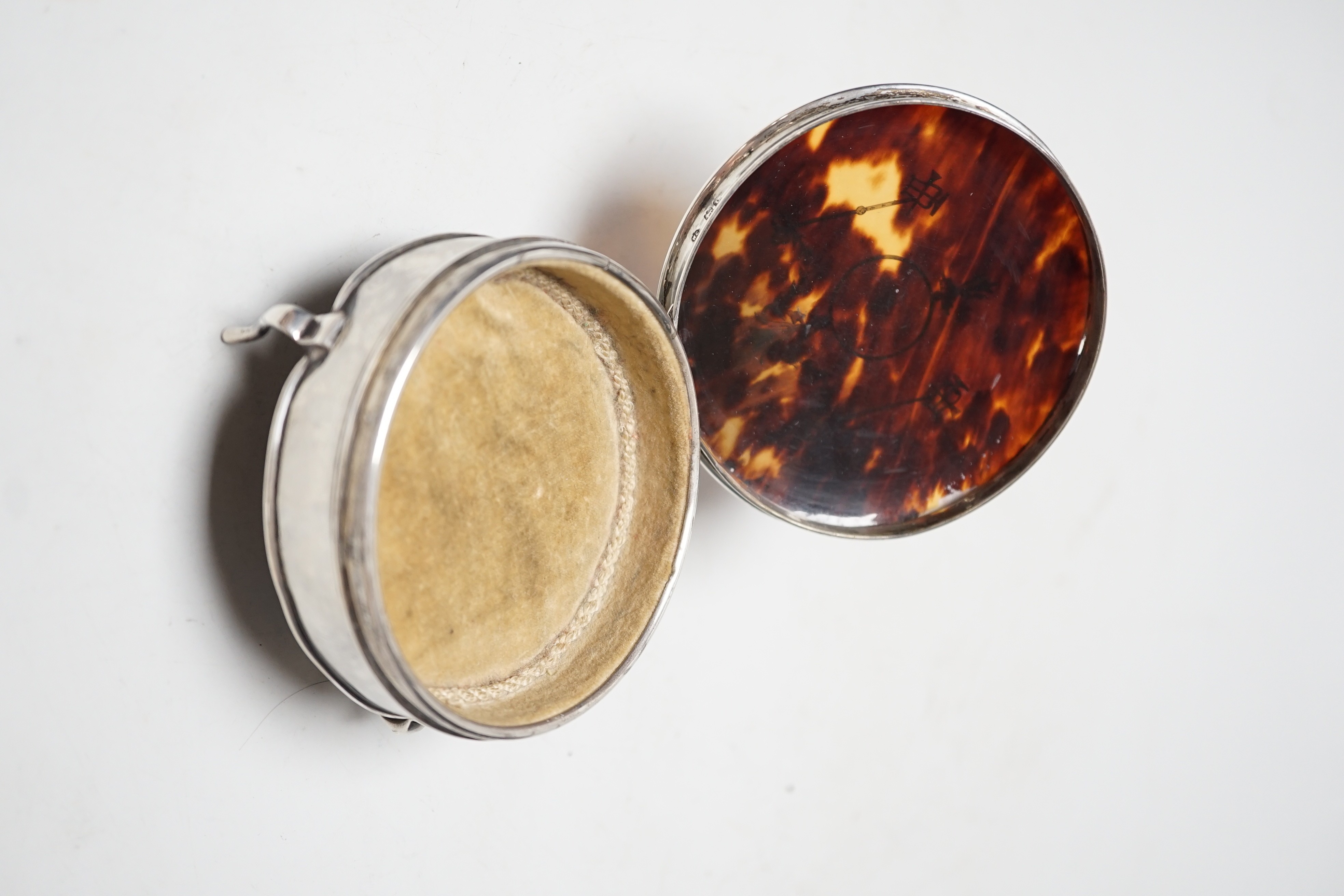 A George V circular silver and pique inlaid tortoiseshell trinket box, William Comyns, London, 1914, width 94mm.